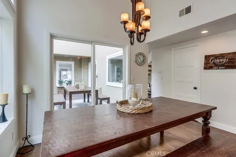 a view of a dining room with furniture and chandelier