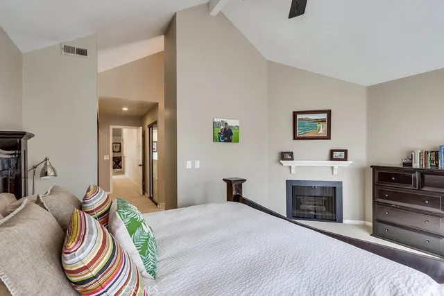 a bedroom with furniture and a fireplace