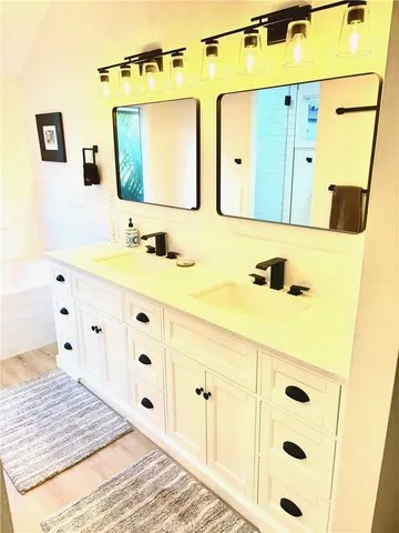 a bathroom with a sink vanity and mirror
