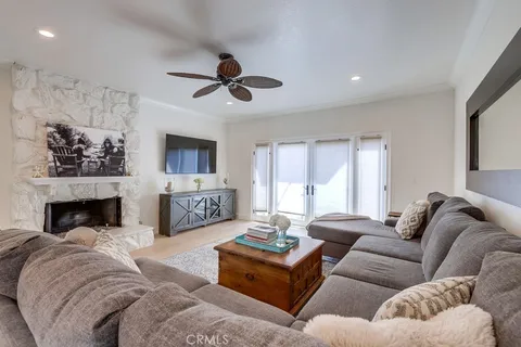 a living room with furniture ceiling fan and a fireplace