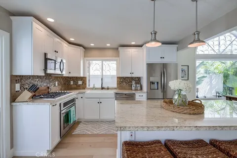 a kitchen with a stove cabinets and window
