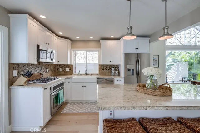 a kitchen with a stove cabinets and window