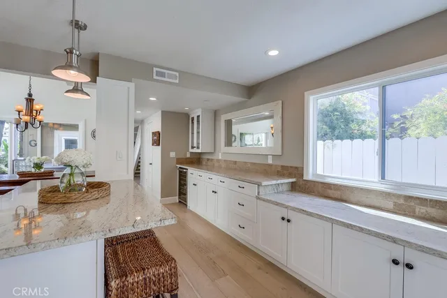 a large kitchen with granite countertop a large window and a sink