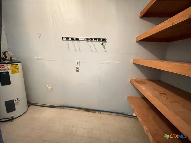 a view of a yard with porch and wooden fence