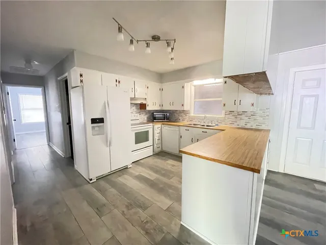 a kitchen with a refrigerator a sink and dishwasher