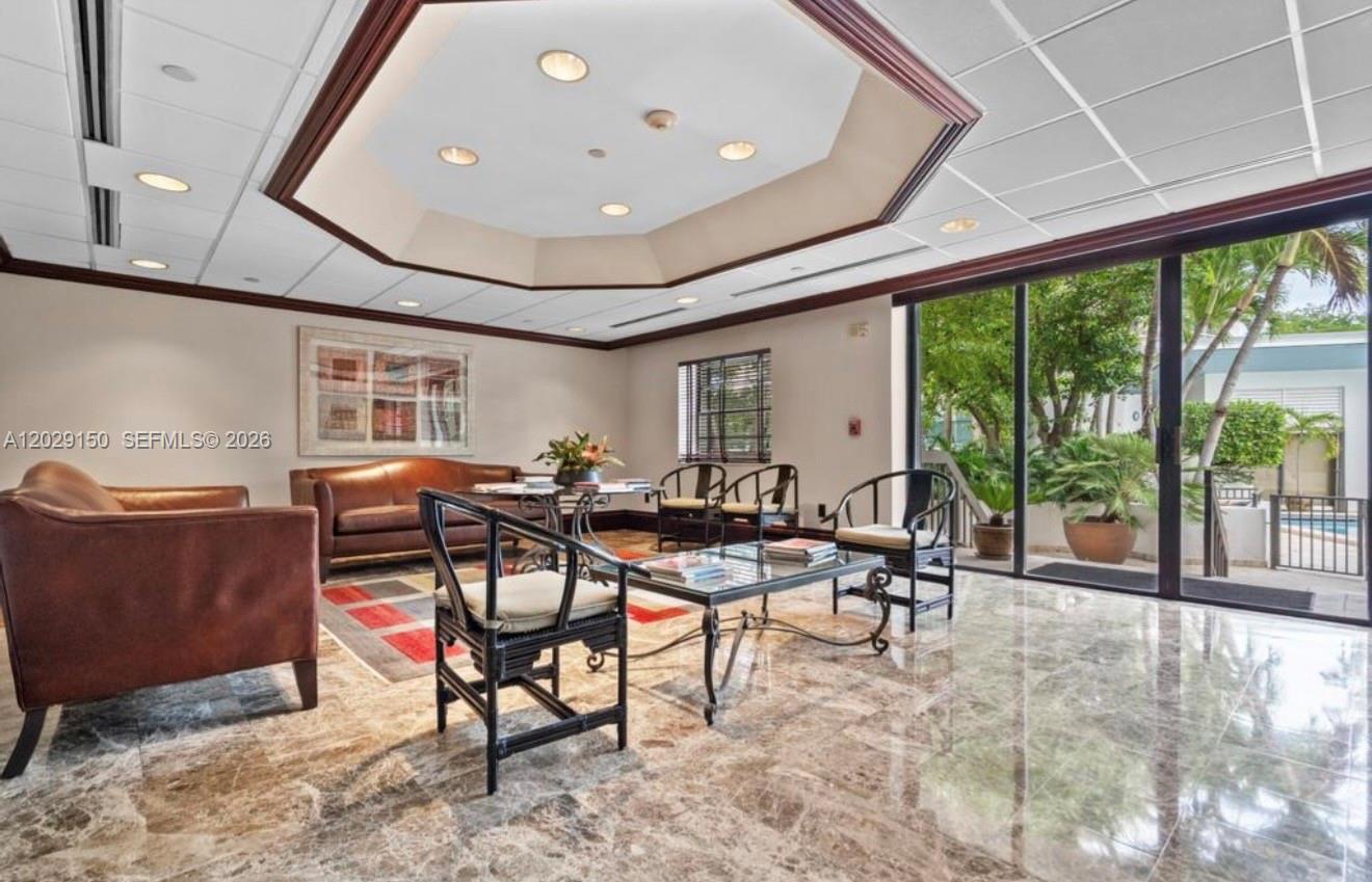 151 Southeast 15th Road, Unit 502 Miami, FL 33129 - Photo 4 of 31 a living room with furniture and a large window