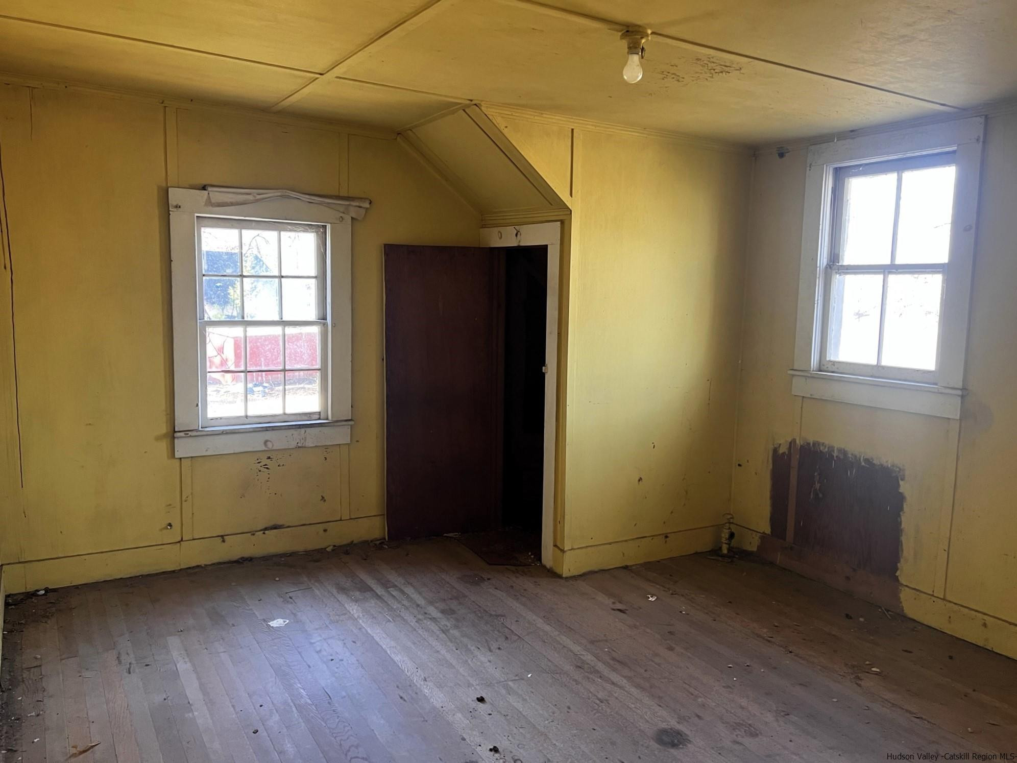 345 Towpath Road Accord, NY 12404 - Photo 19 of 35 an empty room with wooden floor and windows