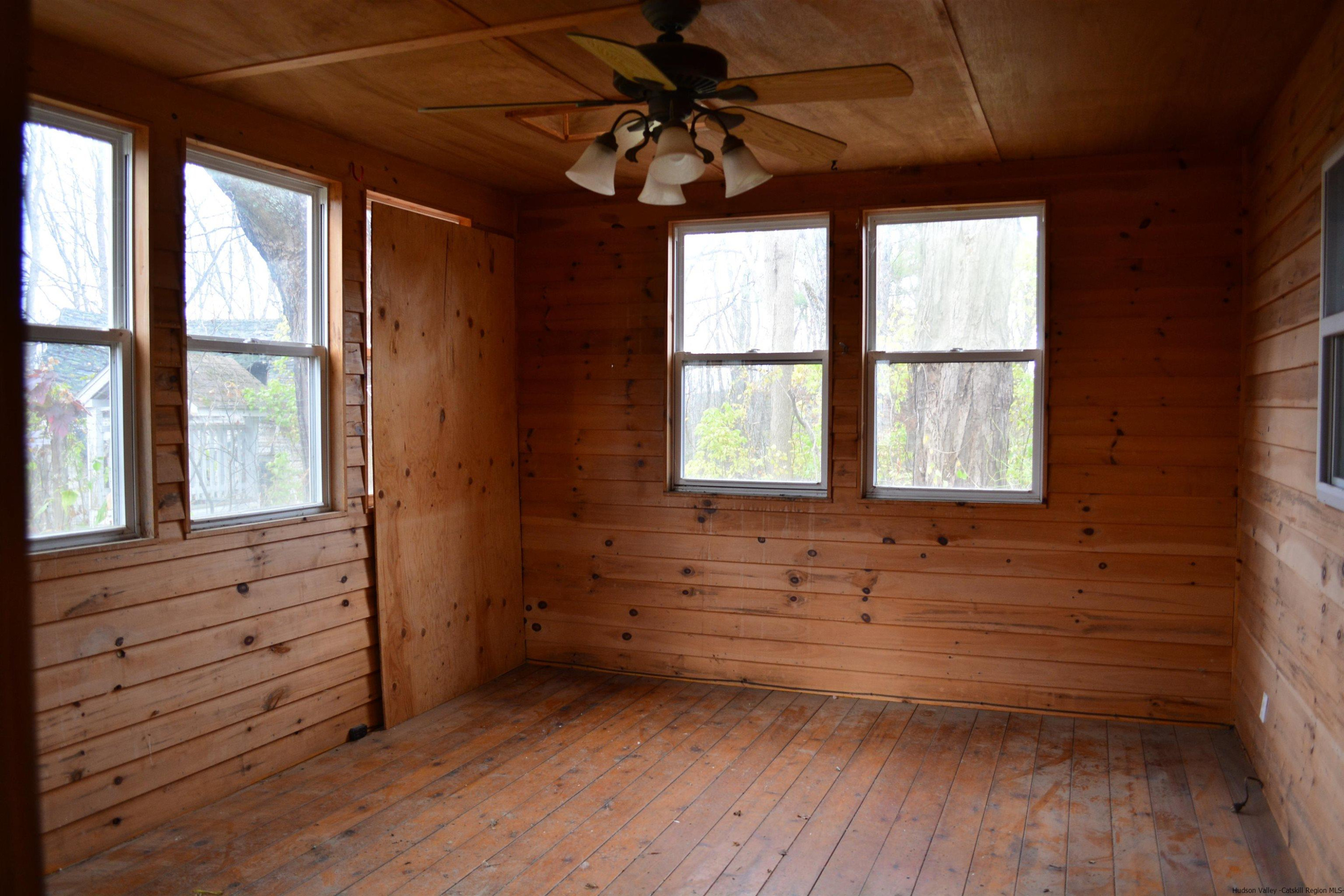 345 Towpath Road Accord, NY 12404 - Photo 26 of 35 a view of empty room with wooden floor and fan