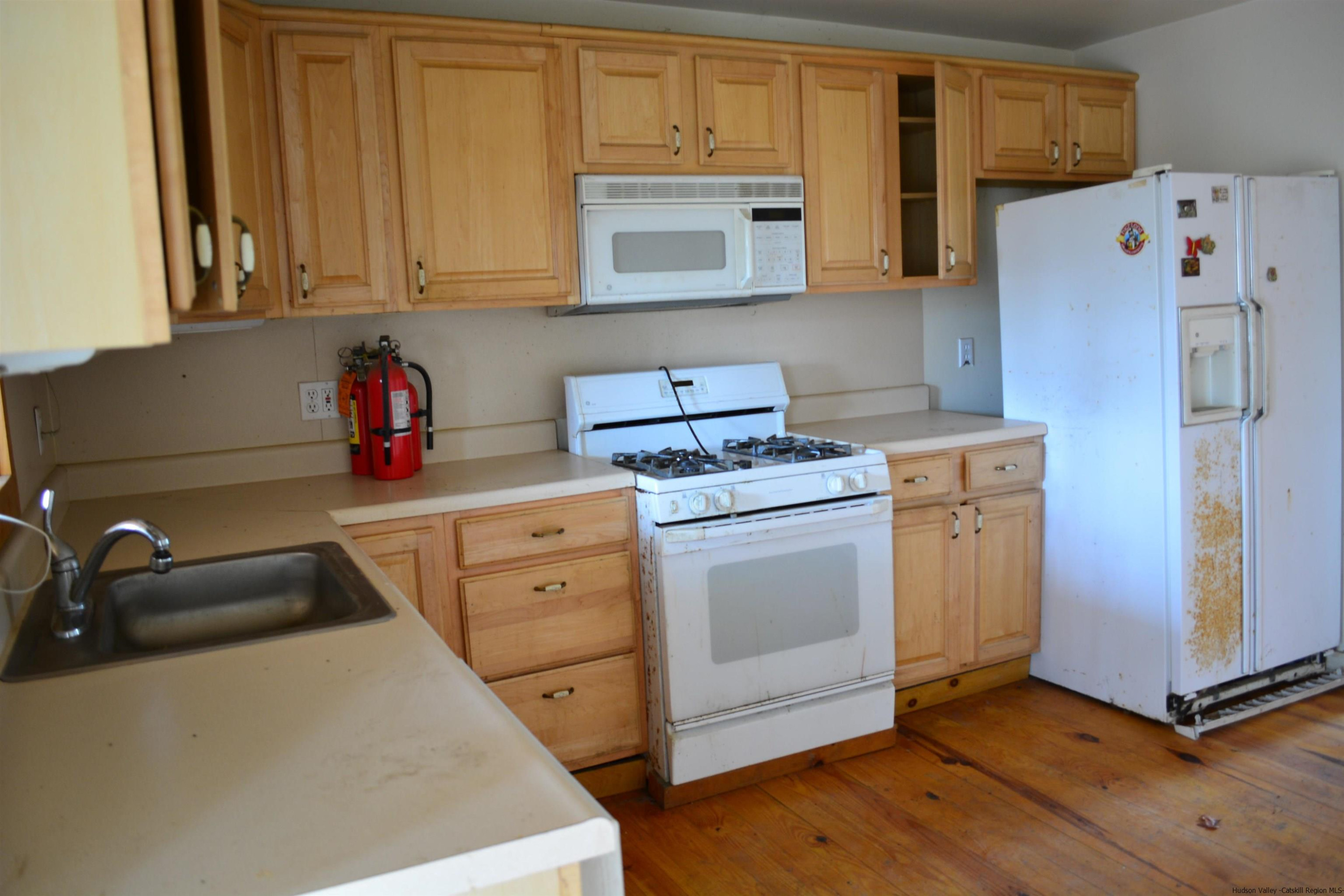 345 Towpath Road Accord, NY 12404 - Photo 27 of 35 a kitchen with a refrigerator stove and white cabinets