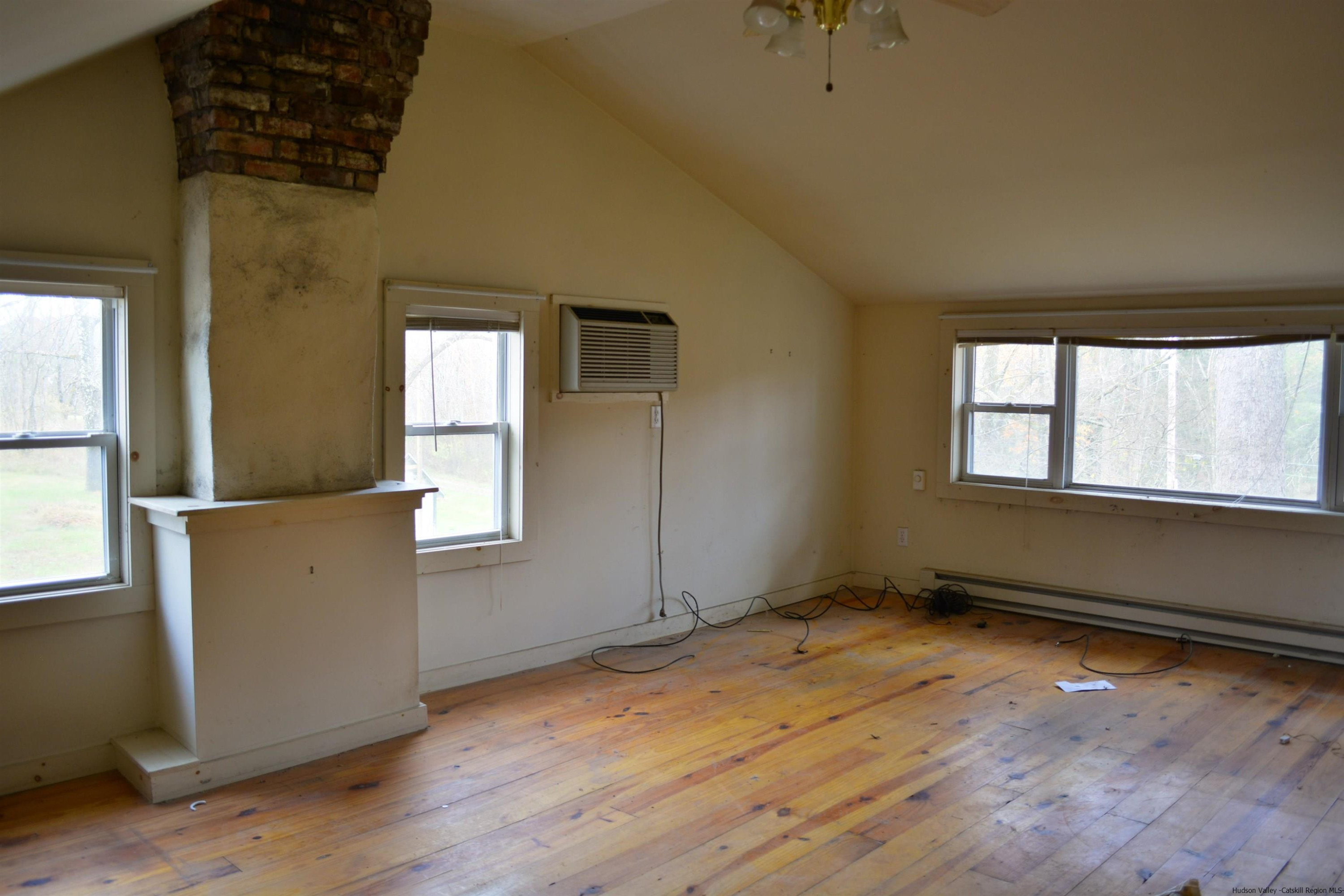 345 Towpath Road Accord, NY 12404 - Photo 29 of 35 an empty room with wooden floor and windows