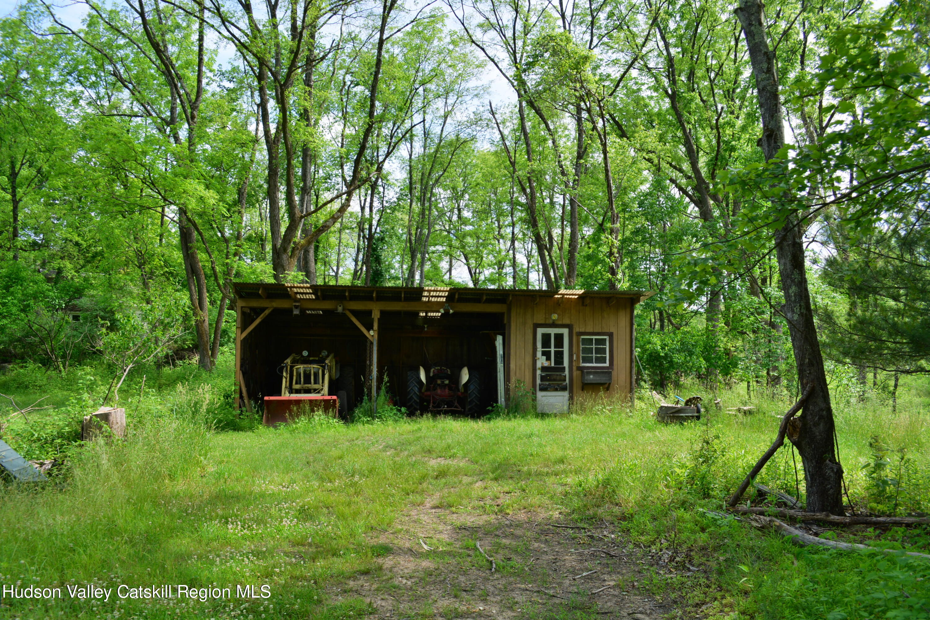 345 Towpath Road Accord, NY 12404 - Photo 33 of 35 a view of a wooden house with a yard and large trees