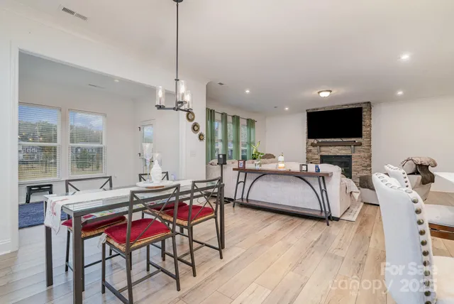 a living room with furniture a flat screen tv and a large window