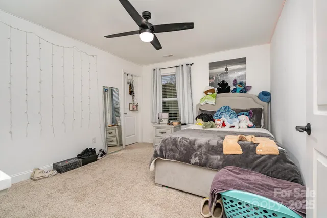 a living room with a bed furniture and a window