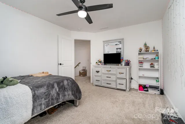 a bedroom with furniture and a flat screen tv