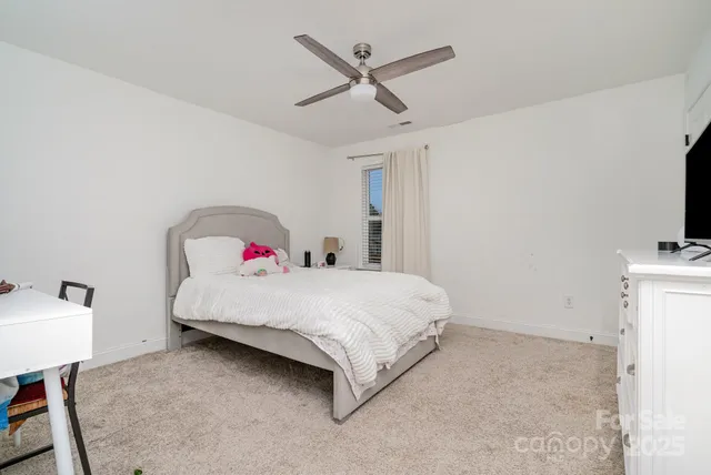 a bedroom with a bed and a tv on the table