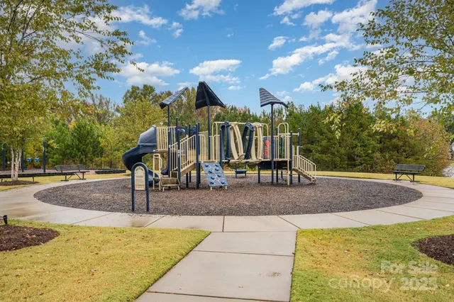 a view of a park with swings and slides