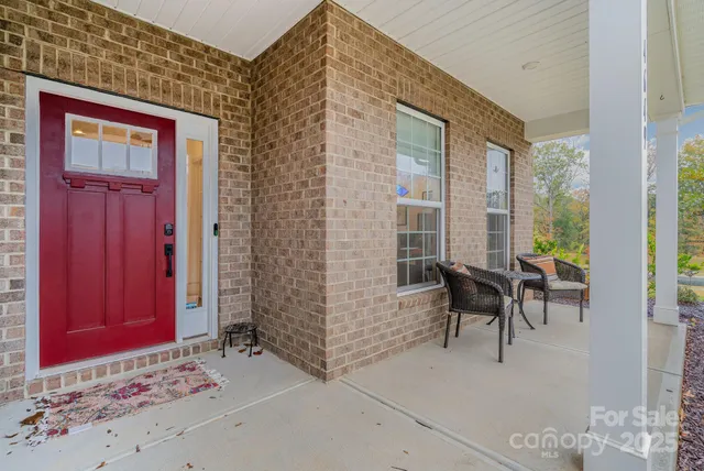 a view of front door with outdoor seating