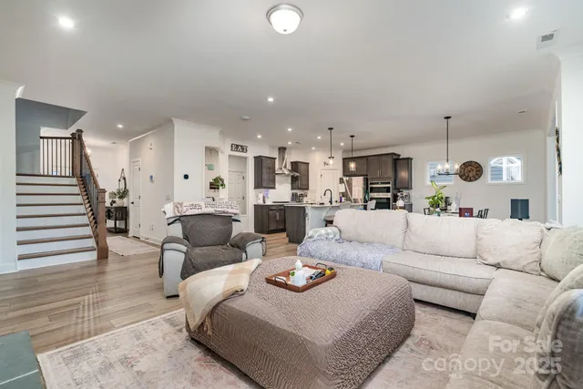 a living room with furniture and kitchen view