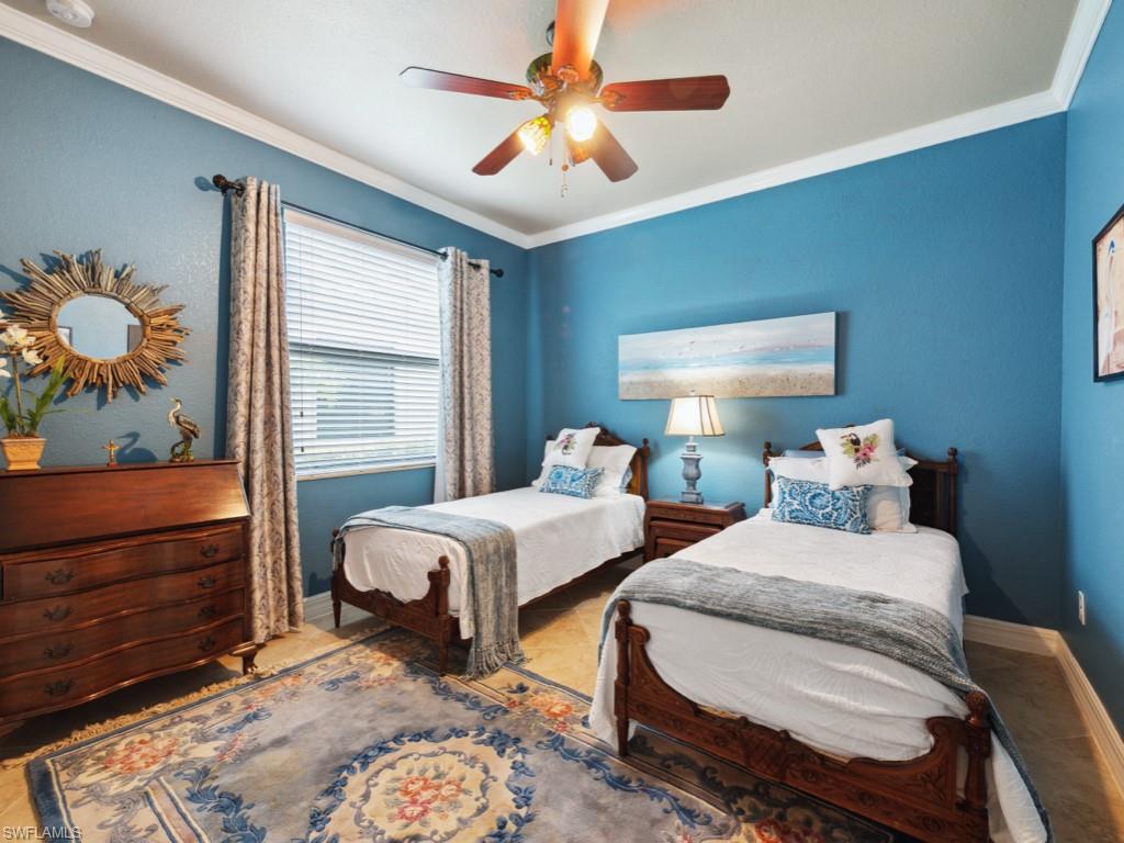 9522 Piacere Way Naples, FL 34113 - Photo 18 of 48 Bedroom featuring baseboards, ornamental molding, and a ceiling fan