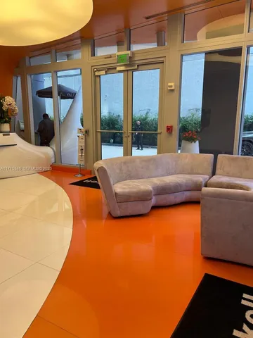 a bedroom with furniture and large window