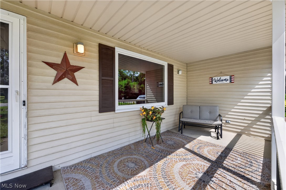 763 Lockwood Road Barberton, OH 44203 - Photo 3 of 24 Covered front porch featuring exterior siding and a window with functional shutters