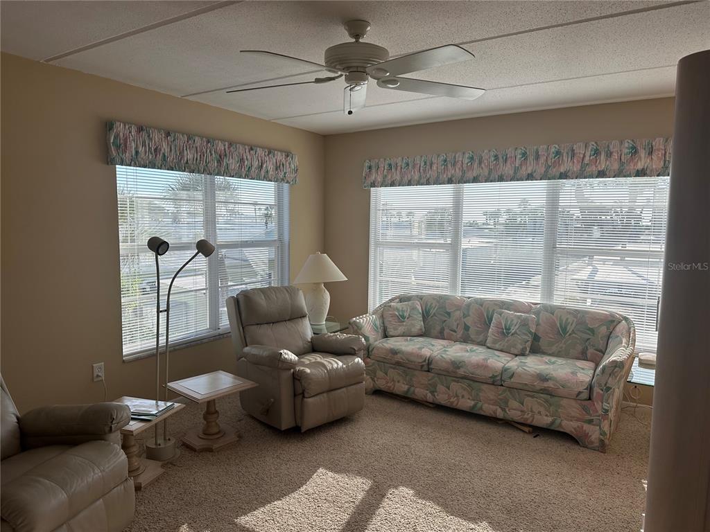 3808 Gulf Of Mexico Drive, Unit E211 Longboat Key, FL 34228 - Photo 11 of 34 a living room with furniture and a large window