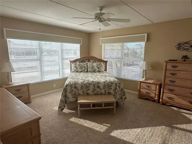 a bedroom with a bed and dresser with mirror