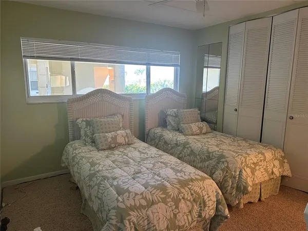 a bedroom with two beds and a window