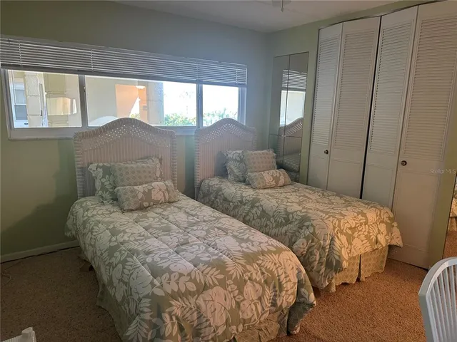 a bedroom with two beds and a window