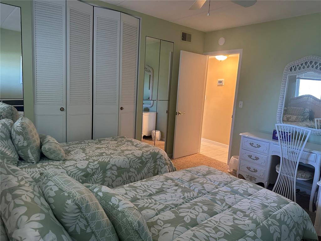 3808 Gulf Of Mexico Drive, Unit E211 Longboat Key, FL 34228 - Photo 18 of 34 a bedroom with a bed and a dresser