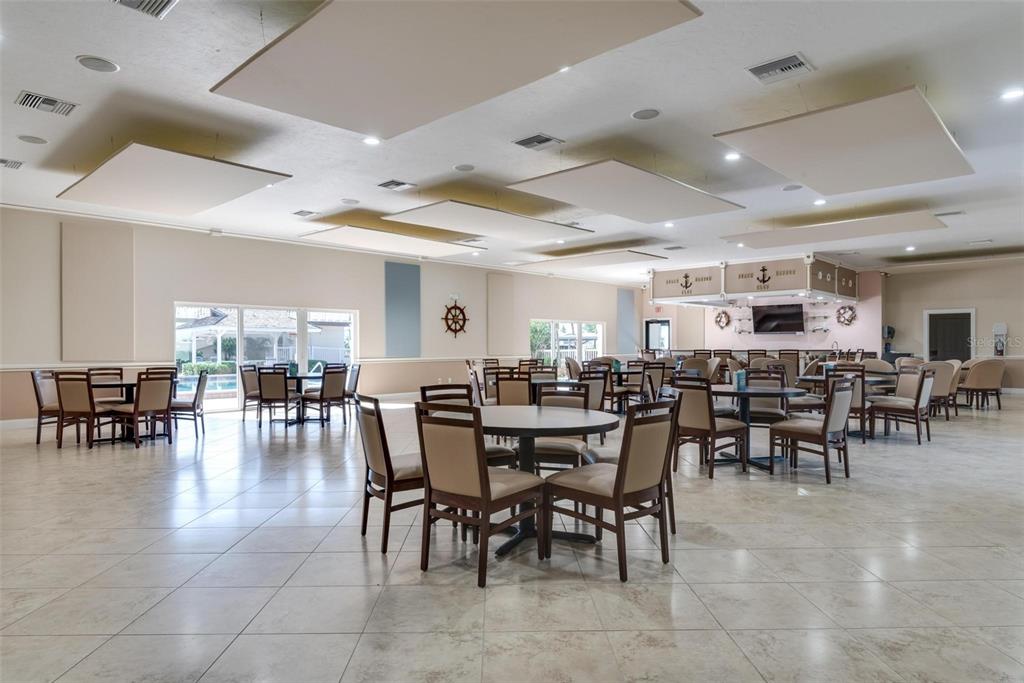 3808 Gulf Of Mexico Drive, Unit E211 Longboat Key, FL 34228 - Photo 30 of 34 a view of a dining room with furniture and chandelier