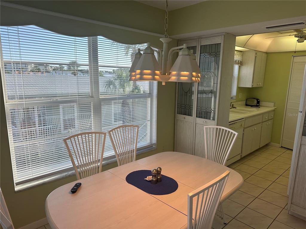 3808 Gulf Of Mexico Drive, Unit E211 Longboat Key, FL 34228 - Photo 3 of 34 a balcony with table and chairs