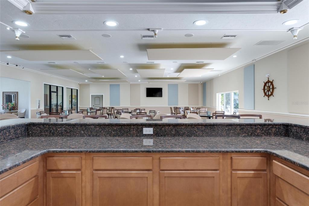 3808 Gulf Of Mexico Drive, Unit E211 Longboat Key, FL 34228 - Photo 32 of 34 a view of a kitchen counter space with granite countertop lots of white cabinets