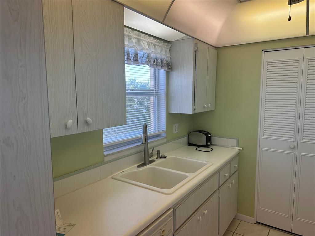 3808 Gulf Of Mexico Drive, Unit E211 Longboat Key, FL 34228 - Photo 4 of 34 a bathroom with a sink and a mirror