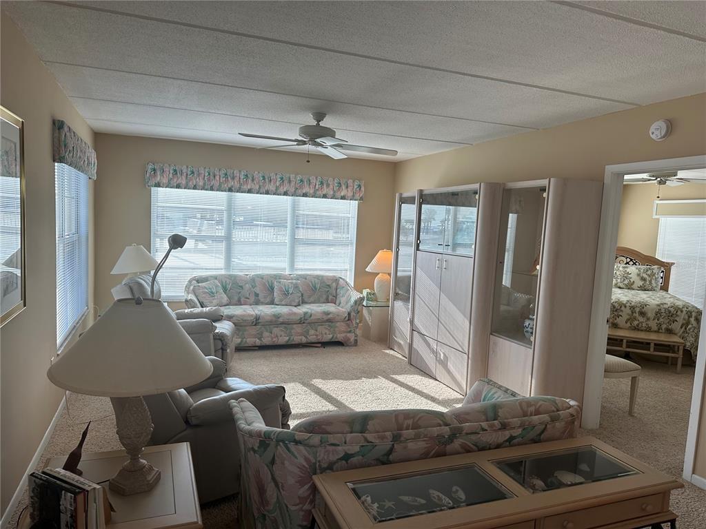 3808 Gulf Of Mexico Drive, Unit E211 Longboat Key, FL 34228 - Photo 10 of 34 a living room with furniture and a window