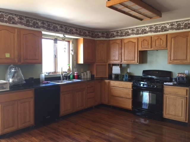 4370 East 250th Road Mendota, IL 61342 - Photo 4 of 23 a kitchen with granite countertop wooden floors and white stainless steel appliances
