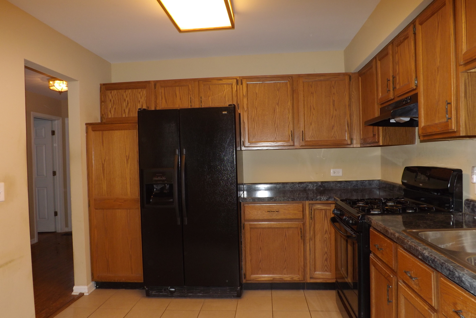 1078 Stillwater Road Elgin, IL 60120 - Photo 7 of 13 a kitchen with stainless steel appliances granite countertop a refrigerator and a stove
