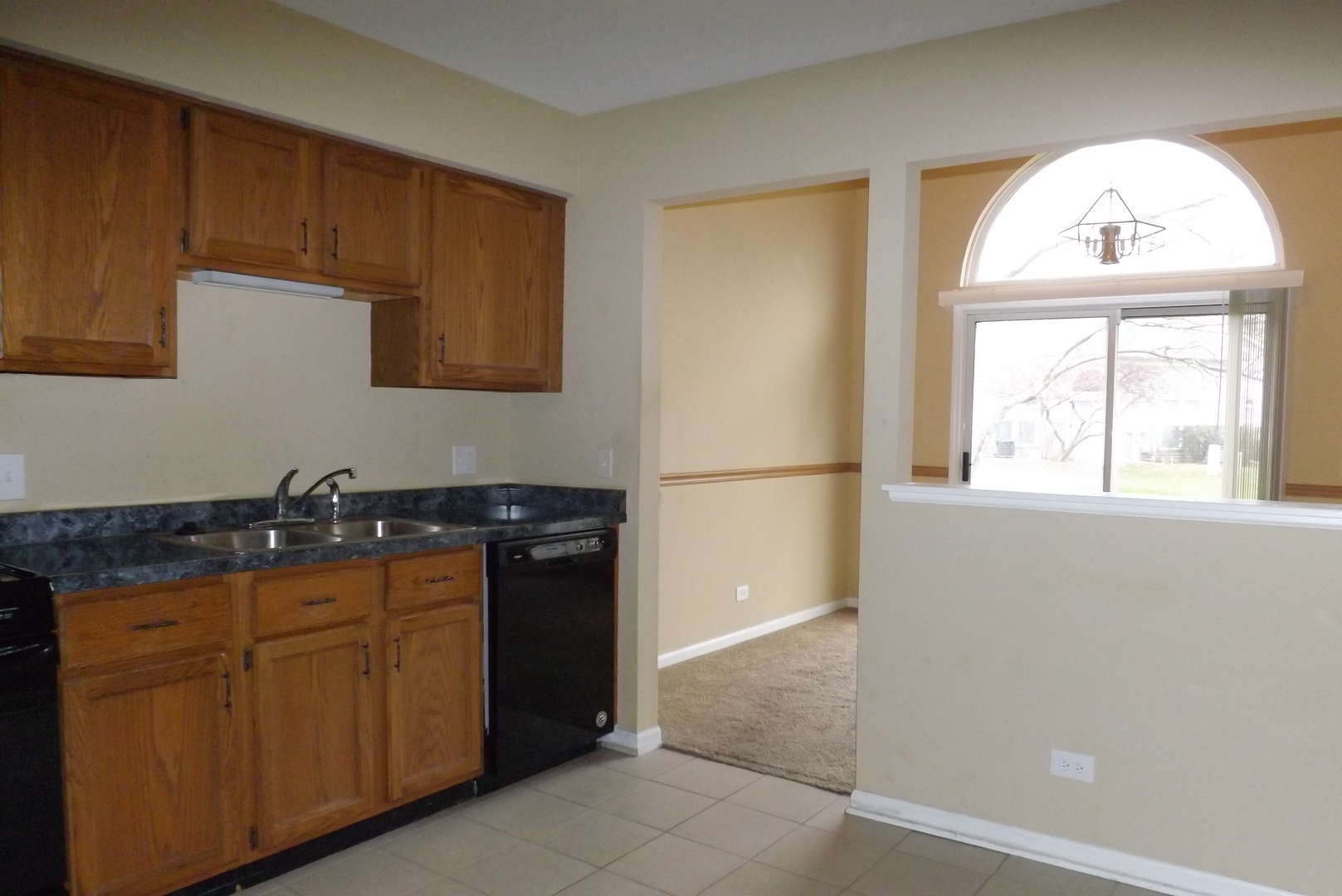 1078 Stillwater Road Elgin, IL 60120 - Photo 9 of 13 a kitchen with granite countertop a stove a sink and a refrigerator