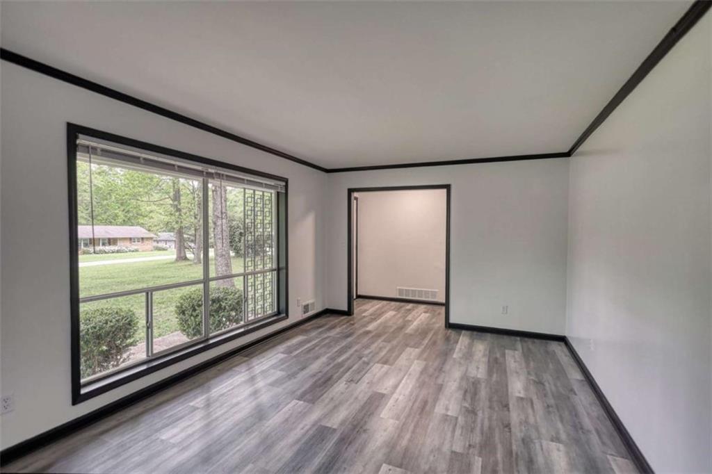 555 Joy Street Jackson, GA 30233 - Photo 15 of 56 an empty room with wooden floor and windows