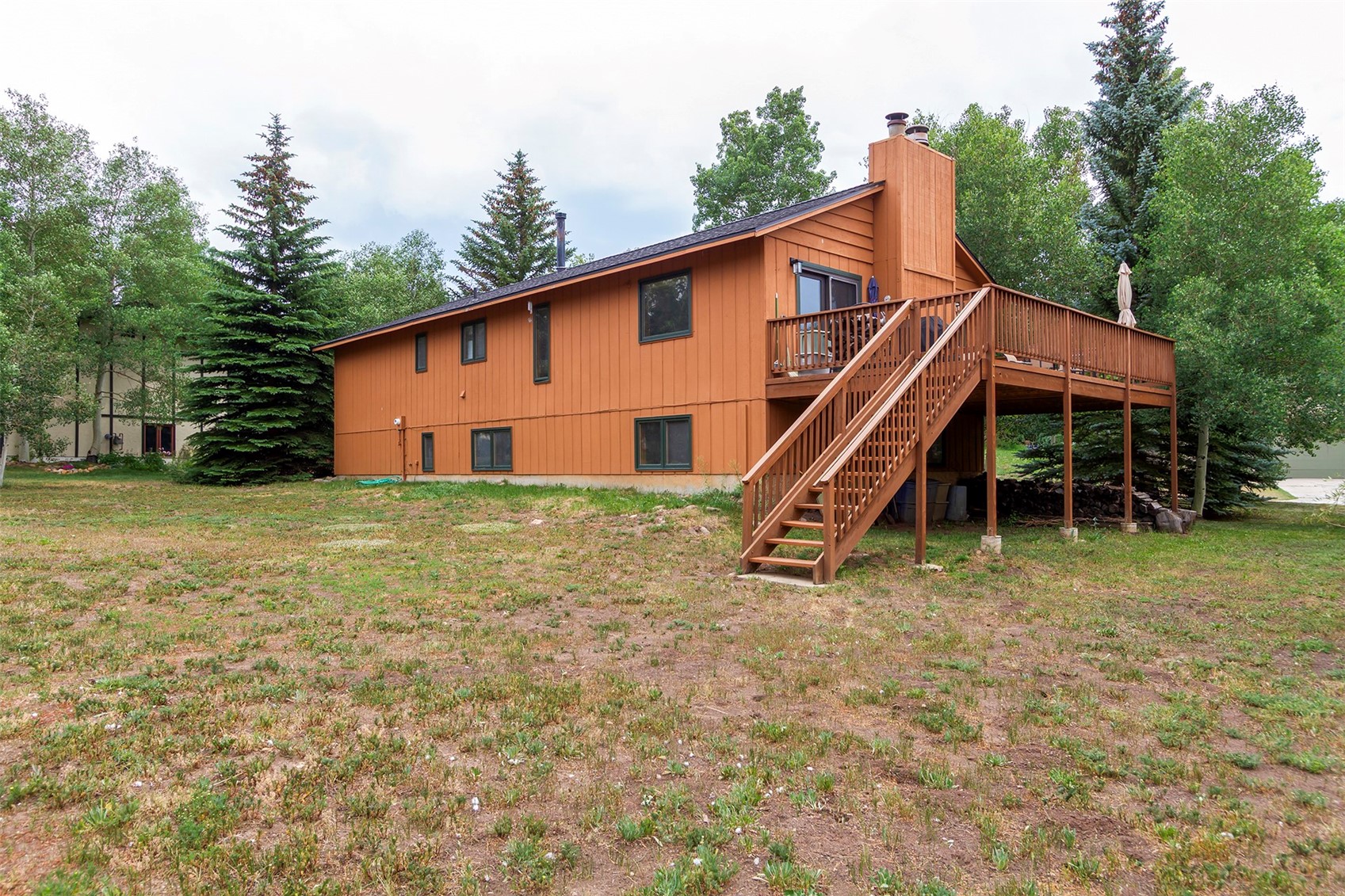 857 Deer Path Road Dillon, CO 80435 - Photo 29 of 29 a backyard of a house with table and chairs