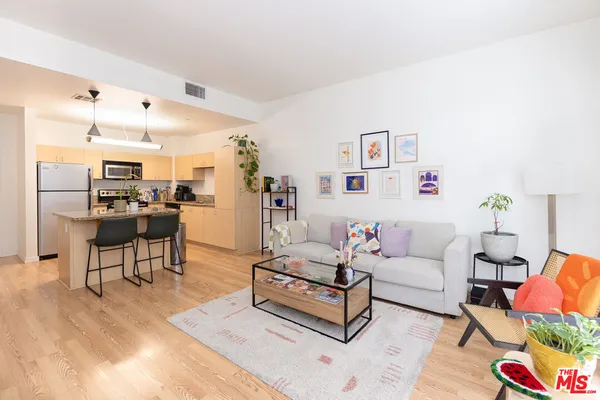 a living room with furniture and kitchen view