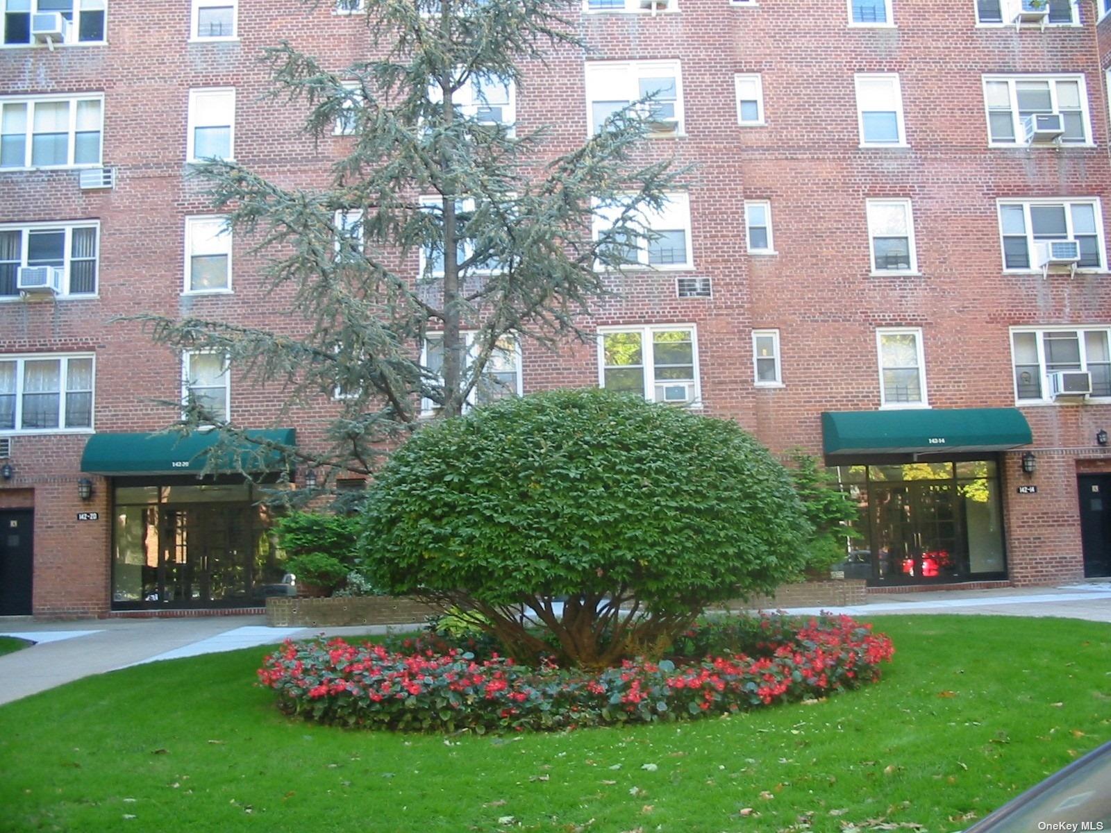 a front view of a building with garden