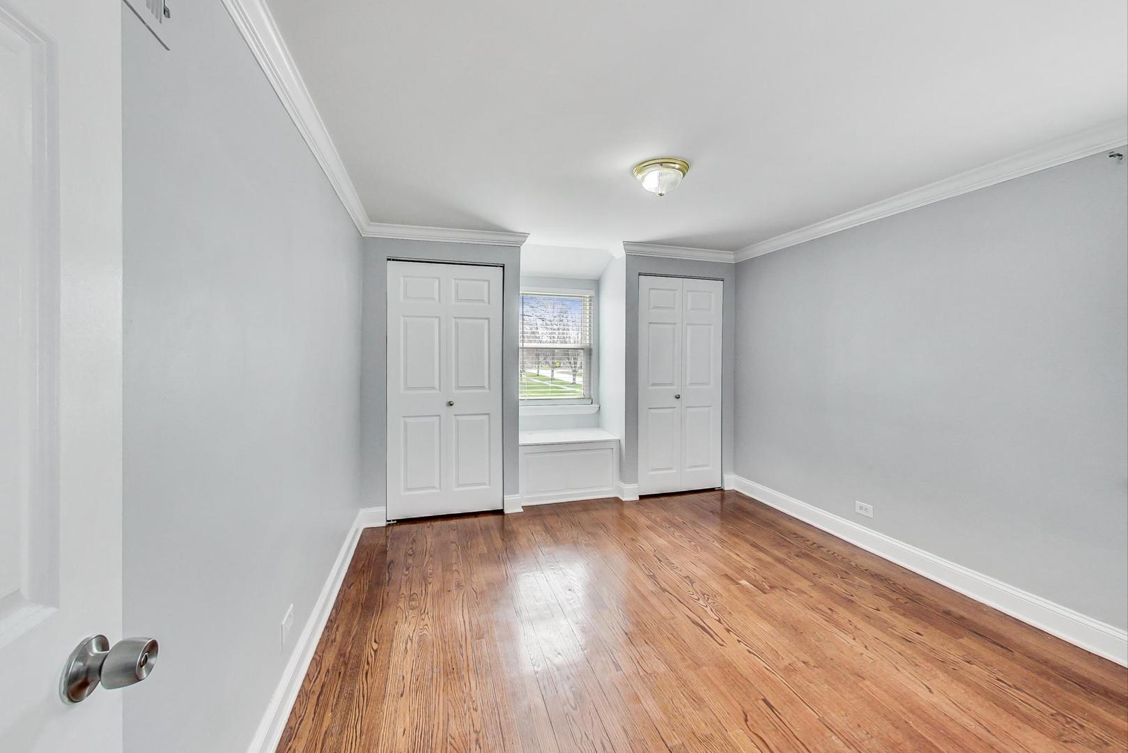 402 North Main Street Mount Prospect, IL 60056 - Photo 12 of 19 an empty room with wooden floor and windows