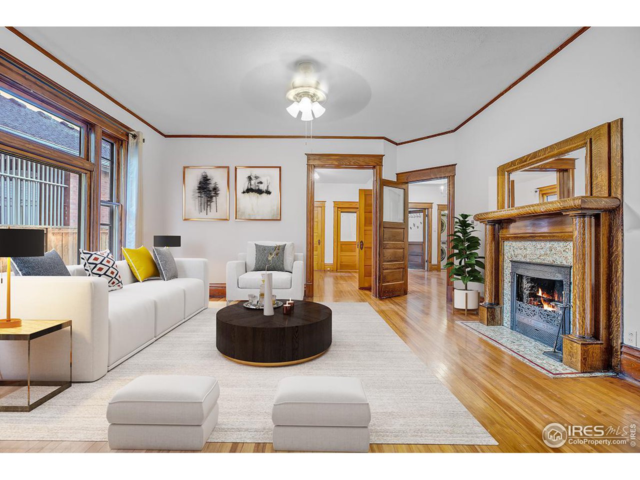 969 10th Street Boulder, CO 80302 - Photo 11 of 40 a living room with furniture a fireplace and a chandelier