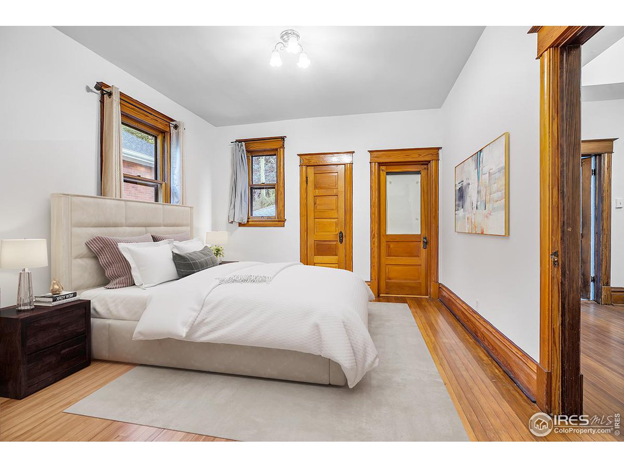 969 10th Street Boulder, CO 80302 - Photo 13 of 40 a bedroom with a large bed and a large window