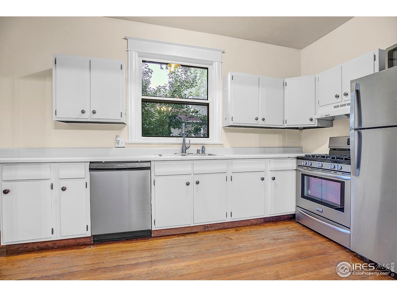 969 10th Street Boulder, CO 80302 - Photo 16 of 40 a kitchen with cabinets appliances a sink and a window