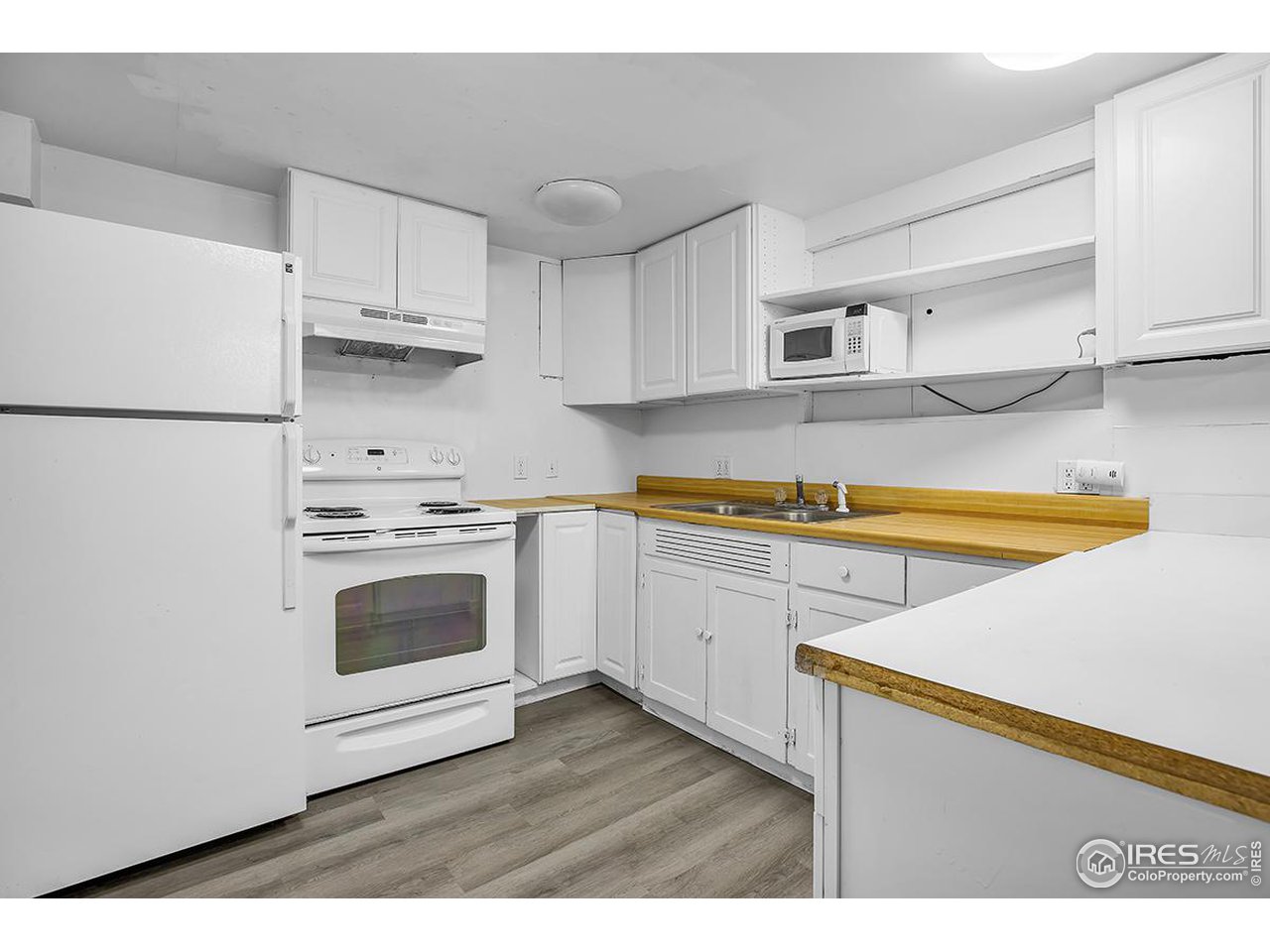 969 10th Street Boulder, CO 80302 - Photo 23 of 40 a kitchen with a white cabinets and white appliances