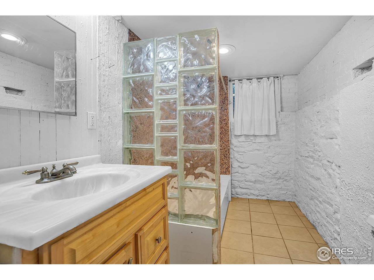969 10th Street Boulder, CO 80302 - Photo 24 of 40 a bathroom with a sink shower vanity and a mirror