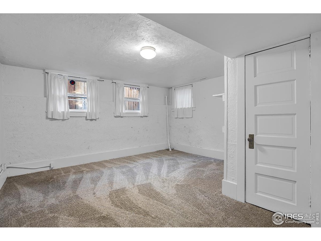969 10th Street Boulder, CO 80302 - Photo 25 of 40 a view of an empty room with closet and a window