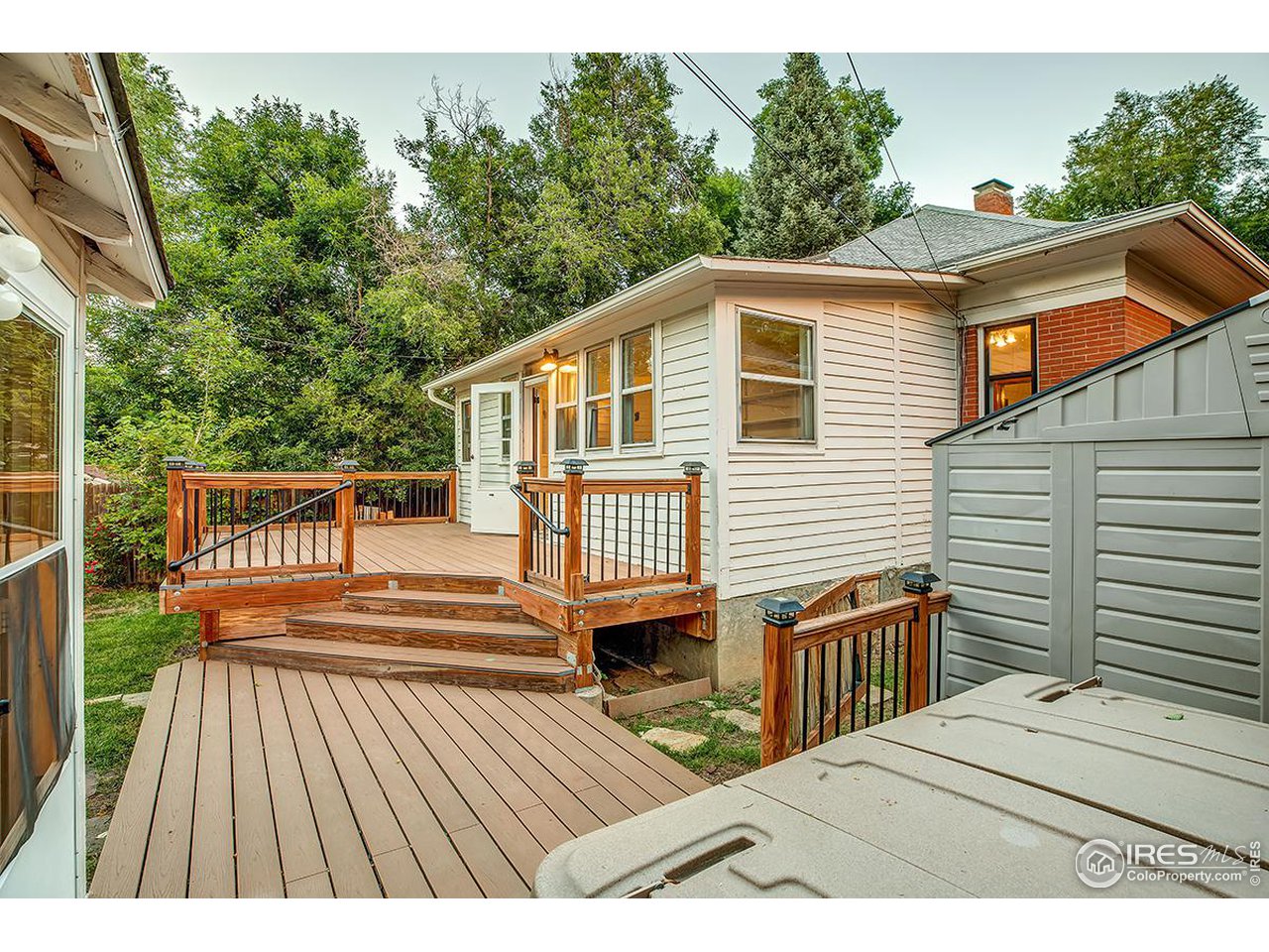 969 10th Street Boulder, CO 80302 - Photo 36 of 40 a view of a wooden deck and a yard with green space